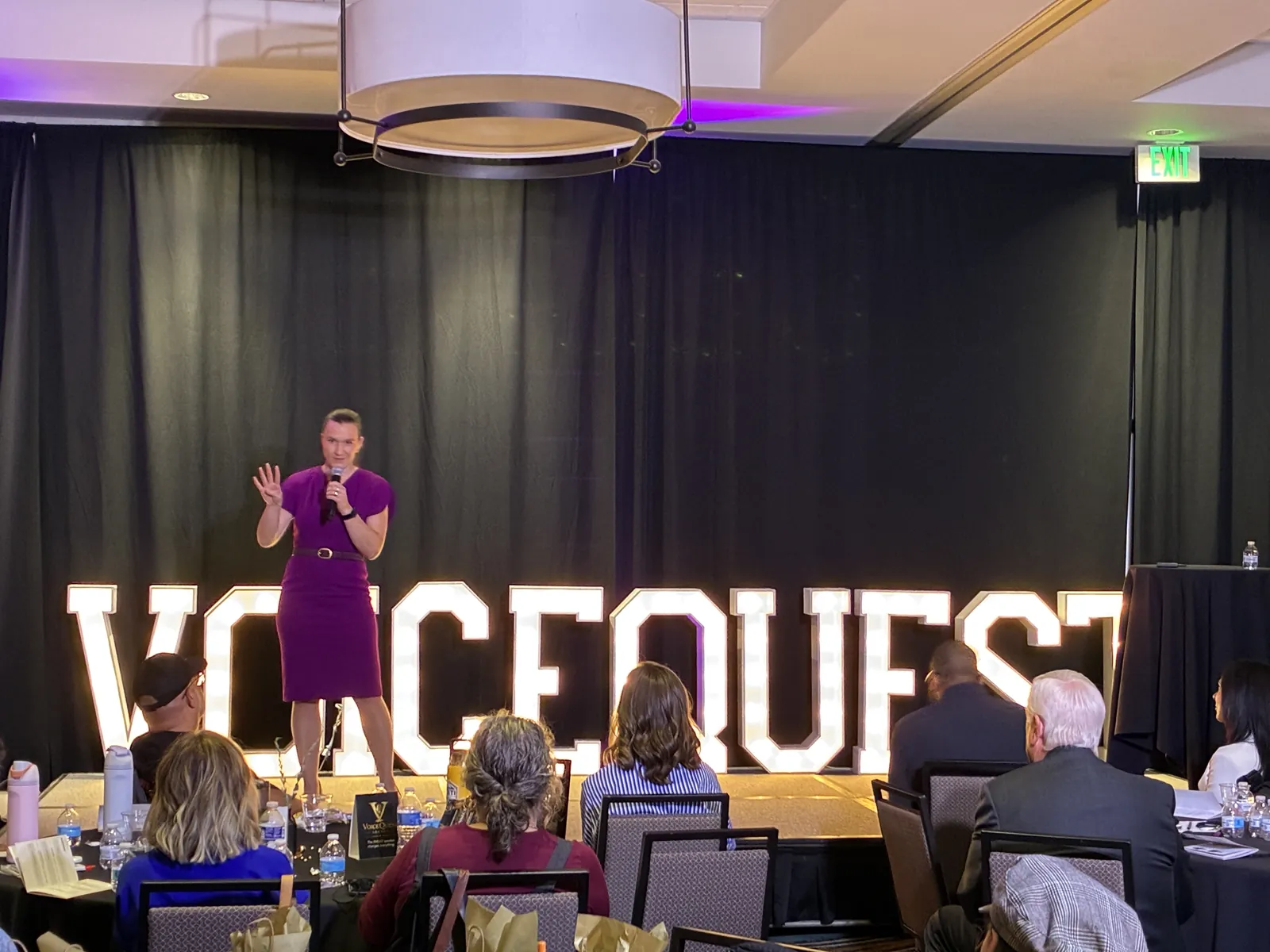 Stephanie Judd delivering a keynote on stage at VoiceQuest