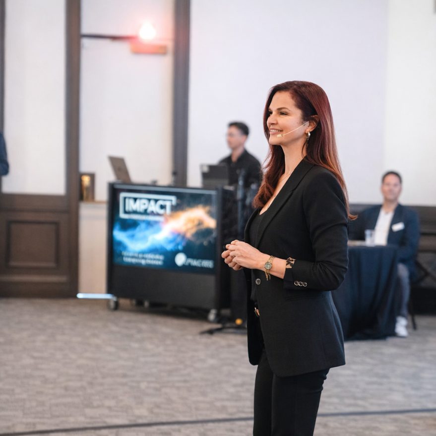 Violet Rainwater speaking on stage at a corporate sales event